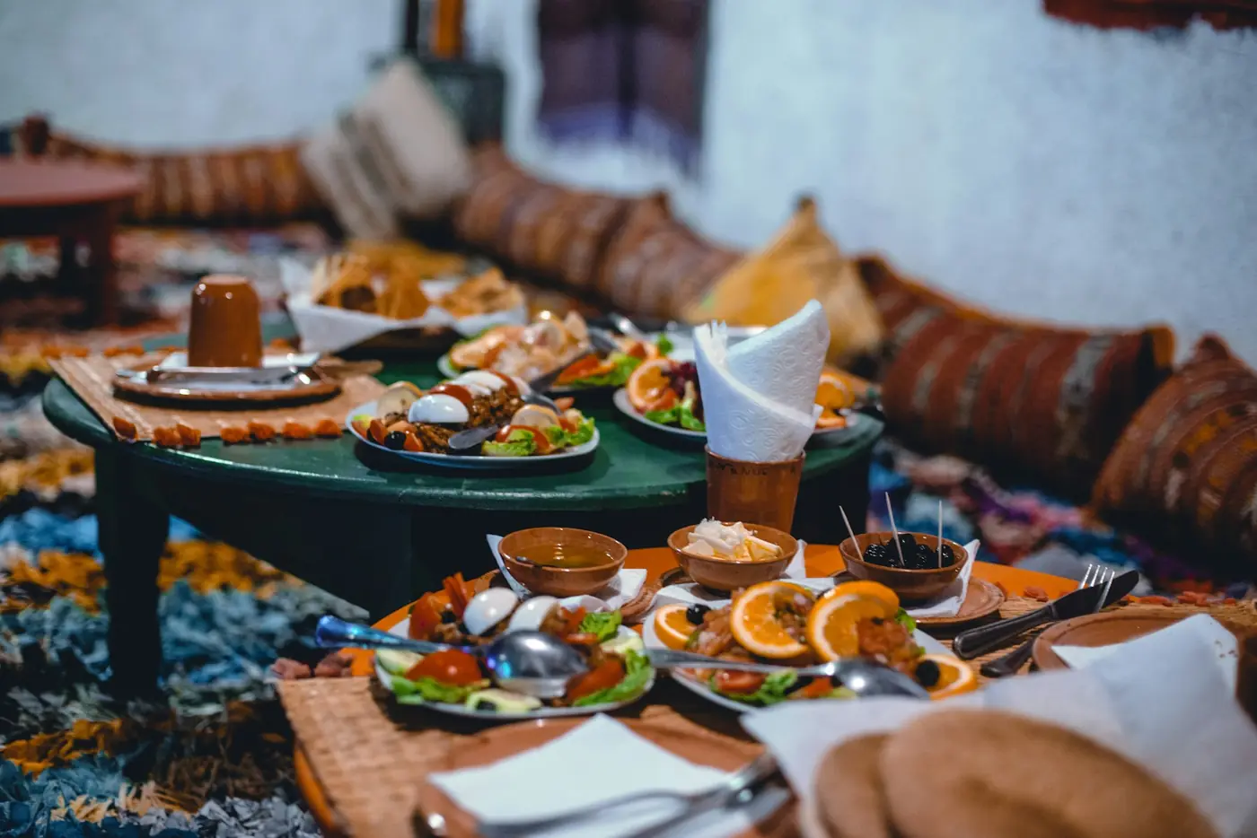 A low table set with tagines, salads, bread and tea